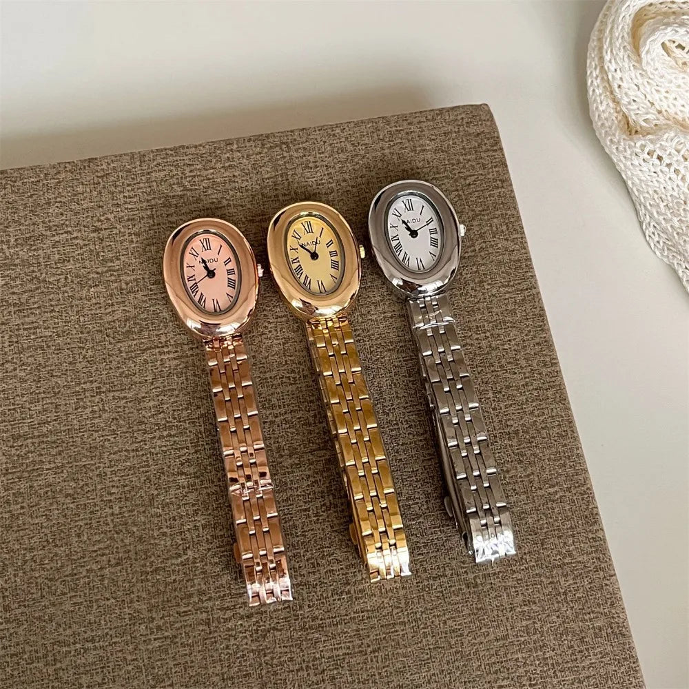 Reloj de moda Hot Sale para mujer, estilo de la antigua Roma, esfera ovalada, reloj pequeño dorado, correa de acero ajustable, reloj de pulsera de cuarzo al por mayor